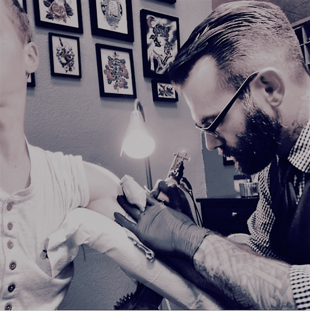 a tattoo artist giving a tattoo