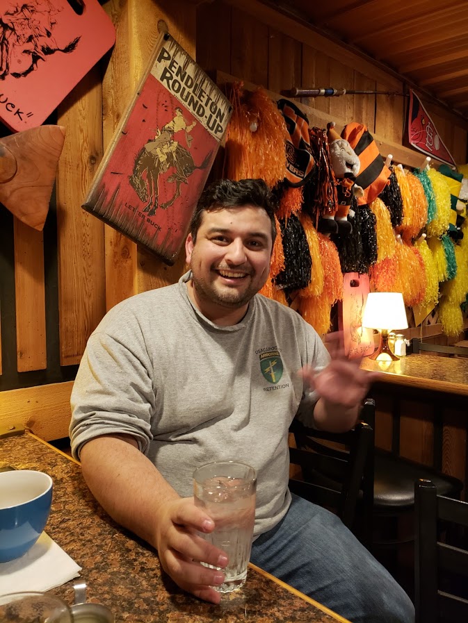 a happy young man in a bar