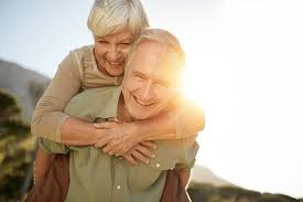 an older lady on an older man's back